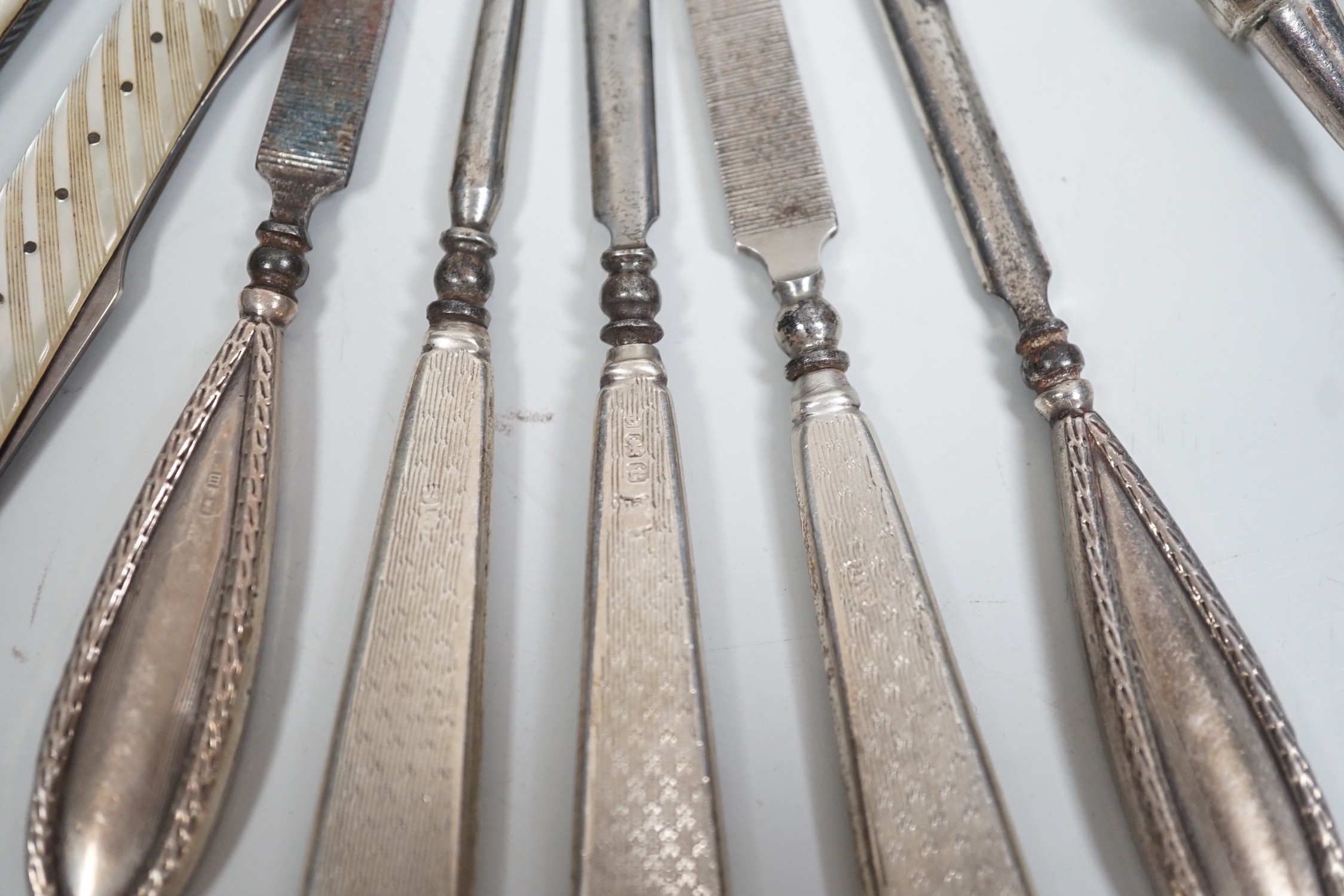 A small group of assorted manicure items and a leather travelling case containing a matched silver and mother of pearl travelling knife and fork.